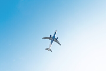 Fototapeta premium Airplane flying high during a clear day providing concepts of travel, journey, and transport