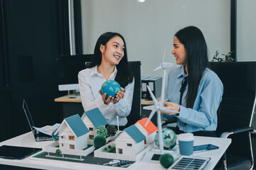 Hands of adult Asian business professionals analyzing ESG financial data and renewable energy project plans