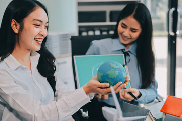 Hands of adult Asian business professionals analyzing ESG financial data and renewable energy project plans