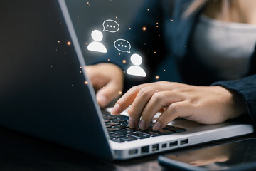 Business professional using laptop with chat icons, representing online conversation, customer interaction, digital communication, support service, and real-time messaging experience.