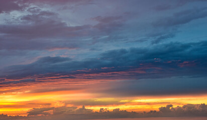 Dramatic blue hour sky with vibrant fiery orange cloud highlights