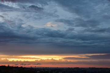Dramatic heavy storm clouds over the Belgrade horizon at golden sunset