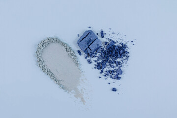 A soft blue eyeshadow stroke and broken shadows of dark blue . different eyeshadow textures. A template to advertise your product. top view.