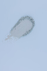 A sample of a stroke of blue eye shadow. The delicate blue texture of the cosmetic brushstroke of decorative cosmetics. top vertical view. copy space