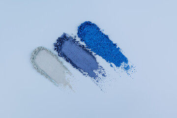Three chic eyeshadow strokes in blue shades of compact eyeshadow. texture of the cosmetic product. Layout of decorative cosmetics. top view