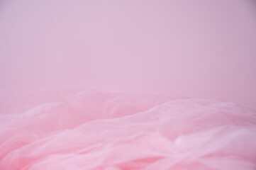 Soft pink background with ethereal tulle fabric texture. Abstract romantic backdrop with copy space for Valentine's Day, wedding, or beauty products