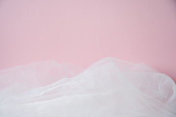 Soft pink background with ethereal tulle fabric texture. Abstract romantic backdrop with copy space for Valentine's Day, wedding, or beauty products