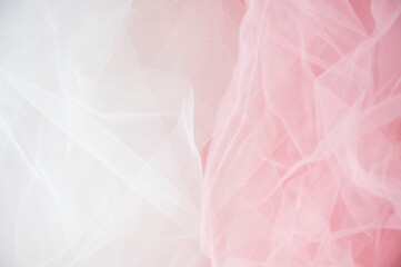 Abstract background of soft white and pink tulle fabric. Delicate mesh texture for wedding, bridal, or romantic feminine designs