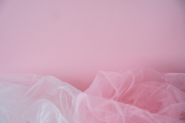 Soft pink background with ethereal tulle fabric texture. Abstract romantic backdrop with copy space for Valentine's Day, wedding, or beauty products