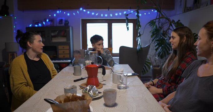 During the family game, a young teenager points and laughs, accusing the imposter.