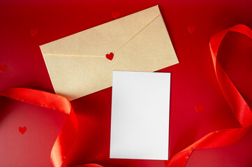 Valentine's Day mockup with blank white card, craft envelope with red heart, and silk ribbon on red background