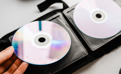 Bunch of CD and DVD discs organized in a disc holder.