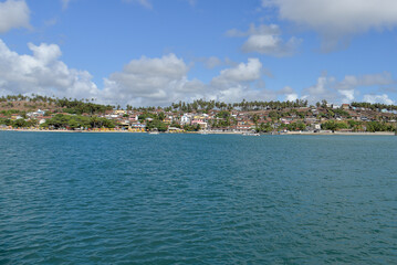 Fototapeta premium panoramic view of barra do cunhaú village from the river, scenic coastal town landscape in rio grande do norte brazil, tropical riverside village with coconut trees and blue water, summer travel desti