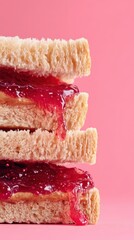 PB&J slice with jelly shine on pastel plate against soft pink field