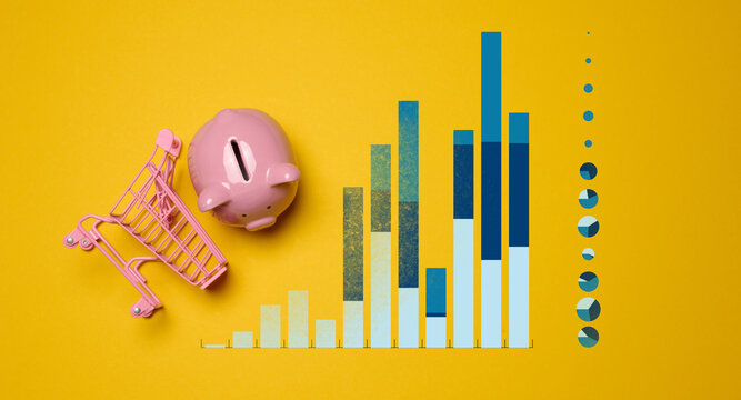 Creative personal finance concept with pink piggy bank, miniature shopping cart and colorful bar chart on bright yellow background, illustrating savings, budgeting, consumer spending and investment pl