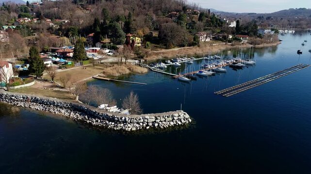Aerial view of Sasso Moro harbor and Leggiuno lakeside village on Lake Maggiore, province of Varese, Lombardy, Italy