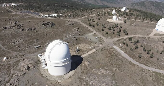 Drone aerial close-up of Calar Alto Observatory dome and access roads, Tabernas Spain, astronomy facility on arid mountain plateau