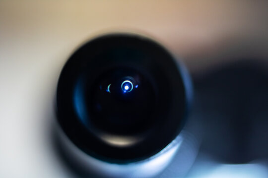 Undetected surveillance captured through atmospheric reflections and grainy film aesthetic