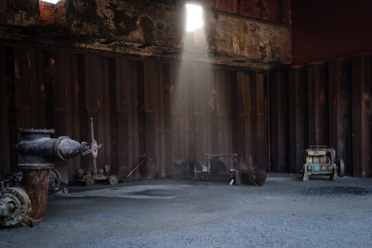 Abandoned Industrial Hall with Light Beam and Rusty Machinery in Landschaftspark Nord Duisburg