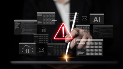 A warning sign indicating potential cyber threats is showcased with a hand holding a stylus against a digital interface displaying various data graphics and security icons. Gantry
