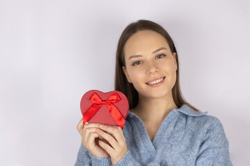 Natural beauty portrait of young woman holding heart shaped gift box. Valentine's day, beauty, lifestyle, love, women's day