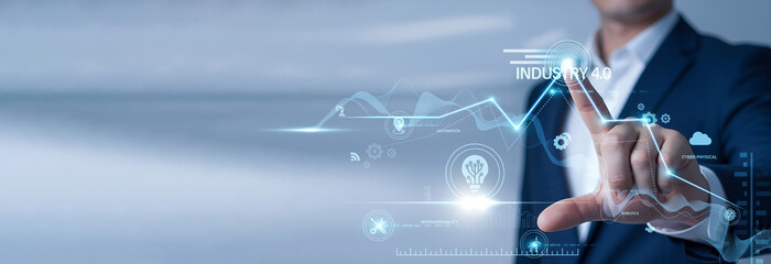 Systems engineer pointing at data network and Industry 4.0 on digital interface. Fourth industrial revolution, smart factory automation, and cyber-physical manufacturing systems.