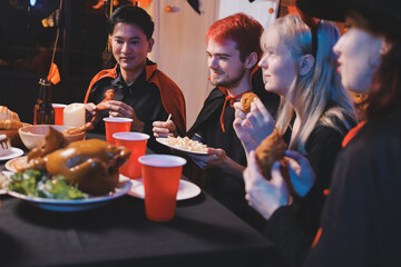 Friends enjoying a Halloween party at a bar making a toast