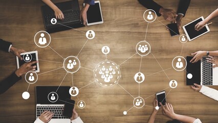 Modern Technology and Networking Concept with Diverse Hands, Laptops, and Tablets in Collaborative Office Environment on Wooden Table Gluon.