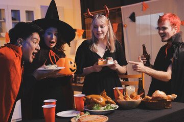 Friends enjoying a Halloween party at a bar making a toast
