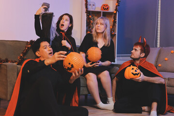 Friends enjoying a Halloween party at a bar making a toast