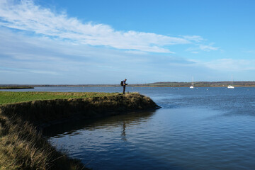 Environmentalist Gathering Climate Change Data at Coastal Flood Defense Levee
