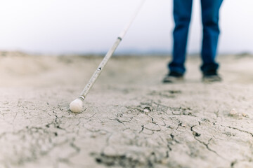 Blind man demonstrating resilience in desert