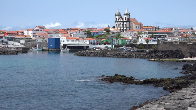 AZORES - 11.3.2025 - Stunning view of a Catholic parish across a harbor on the Azores' Terceira Island.