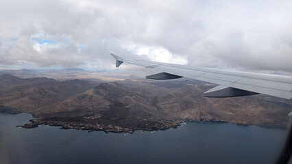 View from airplane window of wing and Fuerteventura island, Spain. 