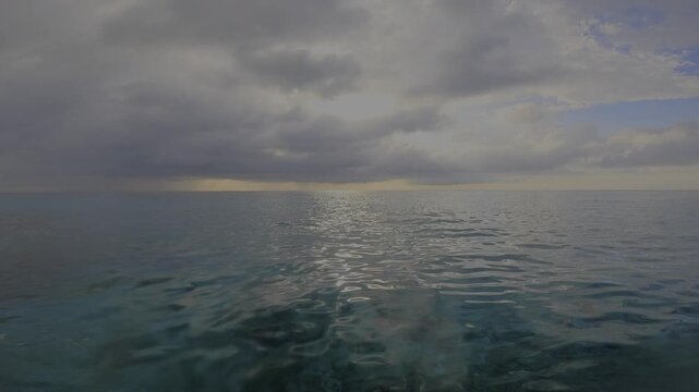 POV Sunset Swim Turquoise Aqua Blue Ocean with Orange Violet Blue Cloudscape