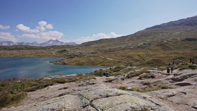 Hikers Overlooking Alpine Lake at Grimsel Pass in Switzerland.Filmed on 30 July 2025.