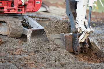 excavator scooping engineered fill with bucket © JohnPaul