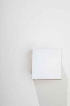 White cube on white surface