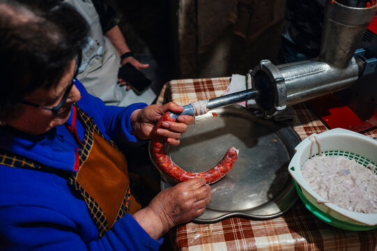 Traditional rural chorizo preparation in a rustic setting