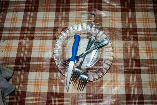 Rustic table setting with utensils on glass plate