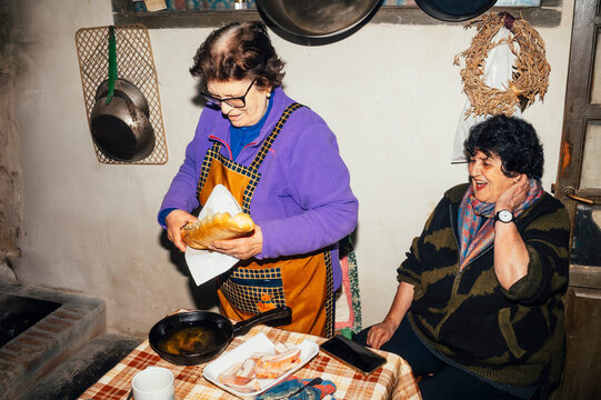 Traditional rural kitchen with pork preparation
