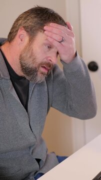 Middle Aged Man Gets Barrage of Internet of Things Smart Home Alerts While Working from Home in Remote Office - IoT Cybersecurity Concept