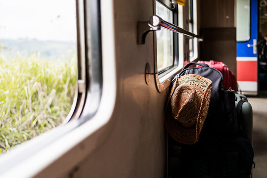 Train interior with travel gear and scenic view