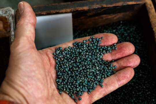 Hand holding raw materials in Taiwan factory