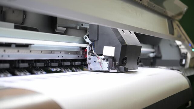The process of printing a large-format printer in the production workshop of the printing house. Production of printing products