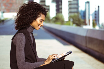 Woman using tablet for work in urban setting