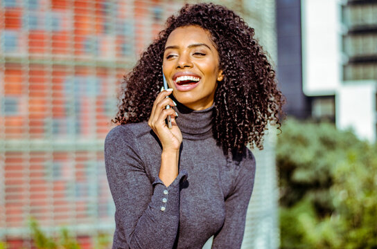 Woman enjoying a phone conversation outdoors