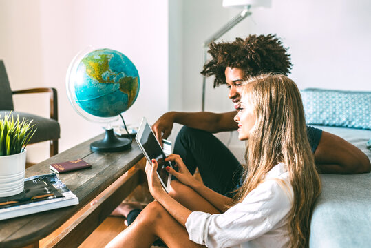Multiethnic couple planning travel at home