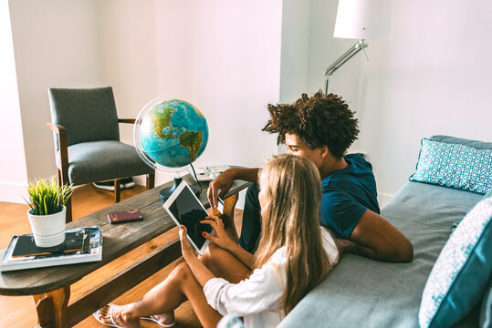 Couple planning travel at home with digital tablet