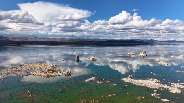 CALIFORNIA - 11.3.2025 - Wonderful aerial footage glides over California's Mono Lake Tufa State Natural Reserve, headed towards low mountains.